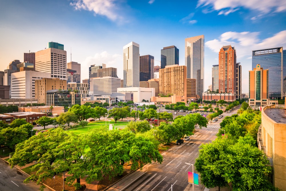 Downtown Houston towers above a tree-lined park.